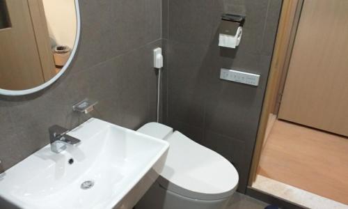 a bathroom with a sink and a toilet and a mirror at Cheongju Hotel Dictionary in Cheongju