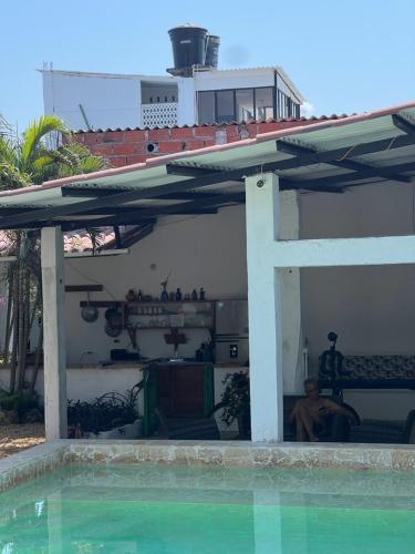 a patio with awning next to a swimming pool at Casa Torices Real 12 in Cartagena de Indias