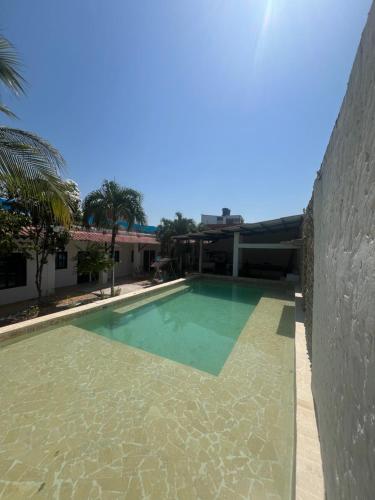 a swimming pool in front of a house at Casa Torices Real 12 in Cartagena de Indias