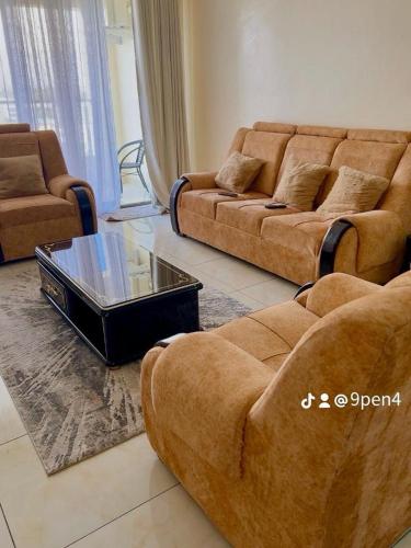 a living room with two couches and a coffee table at 3RD Ave. Beach Apartment Nyali, Mombasa, North Coast in Nyali