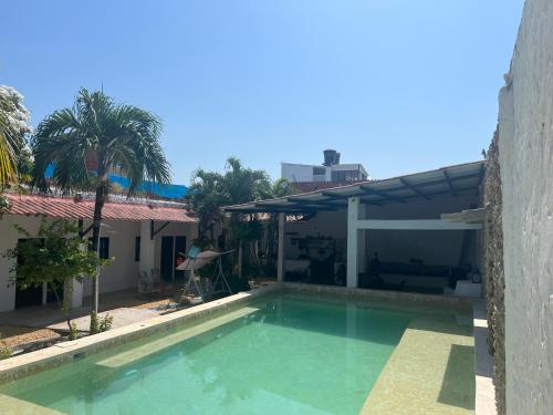a swimming pool in front of a house at Casa Torices Real 12 in Cartagena de Indias