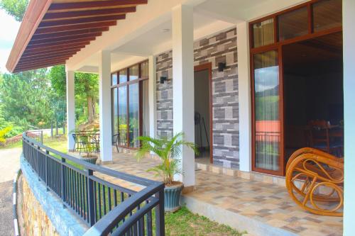 a front porch of a house with a blue railing at Camellia Rise in Kandy