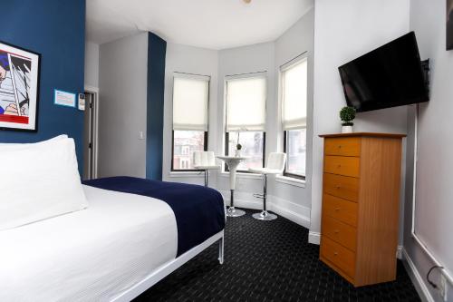 a hotel room with a bed and a tv at Heart of South End, Convenient, Comfy Studio #42 in Boston