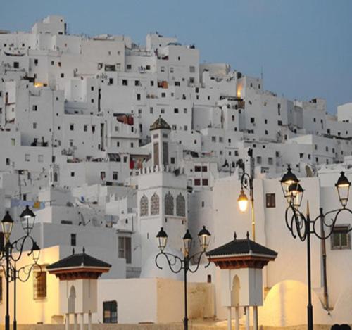 a large white building with lights in front of it at Flat In Tetouan City Centre Medina - NEW Dar Azhar in Tetouan