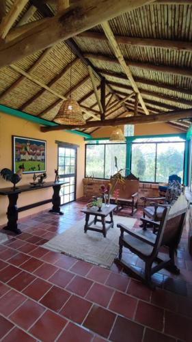 a living room with tables and chairs in a building at casa encanto campestre in Pescadero