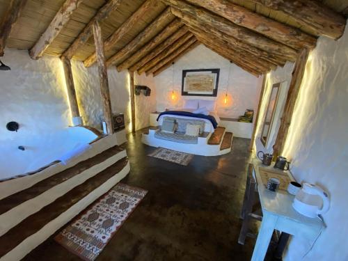 an overhead view of a bedroom with a bed and a sink at Hobbit Hotel Ecolodge- Guatapé in Guatapé