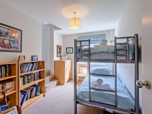 a room with two bunk beds and a book shelf at 4 Bed in West Holme DC204 in East Stoke