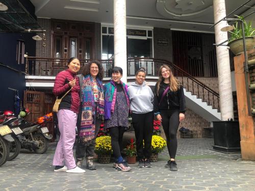a group of women standing in front of a building at Nam Phương Riverside Villa in Hue