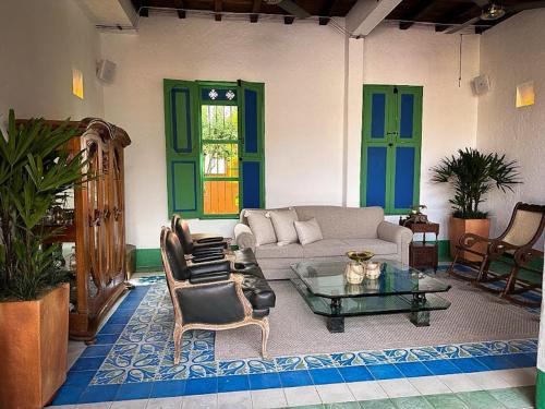 a living room with a couch and chairs and a table at Casa Cedrela Hotel Boutique by HMC -Cauca Viejo- Mayores de 14 años in Jericó