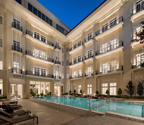 an exterior view of a building with a swimming pool at The Grand Mansion Menteng by The Crest Collection in Jakarta