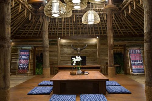 a room with a table with flowers on it at Lelewatu Resort Sumba in Watukarere