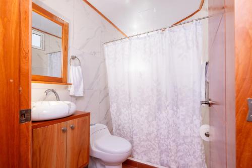 a bathroom with a shower and a toilet and a sink at EXCLUSIVE CONDO GALAPAGOS and BEYOND 1 in Puerto Ayora