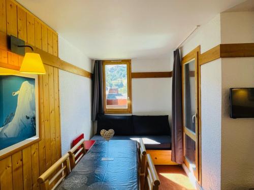 a living room with a couch and a window at Appartement La Plagne-Tarentaise, 2 pièces, 5 personnes - FR-1-351-163 in La Plagne Tarentaise