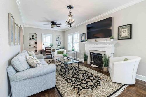 a living room with a couch and a fireplace at Beautiful 5BR/4BA Luxury Historic Home on Success in Lakeland