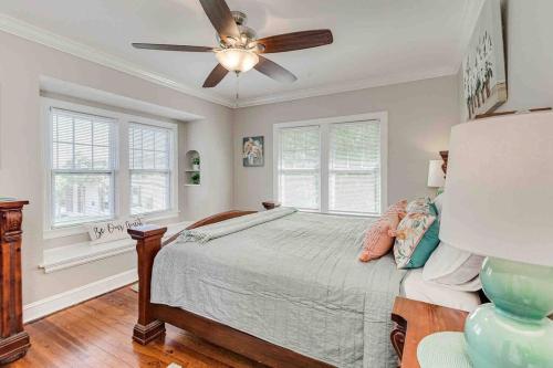 a bedroom with a bed and a ceiling fan at Beautiful 5BR/4BA Luxury Historic Home on Success in Lakeland