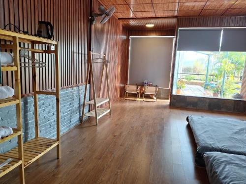 a room with a large window and a room with a bed at Windy Home in Ấp Man Ling