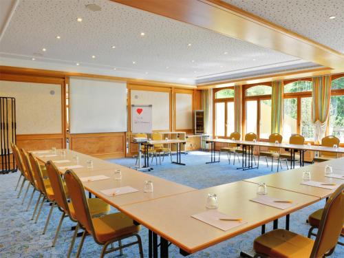 a conference room with tables and chairs in it at Ringhotel Mönch`s Waldhotel in Unterreichenbach