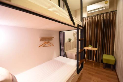a small room with a bed and a bathroom at Silom Forest Exclusive Residence in Bangkok