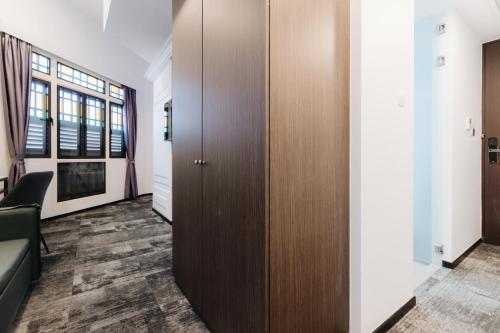a corridor of an office with a door and a room at Santa Grand Hotel East Coast a NuVe Group Collection in Singapore