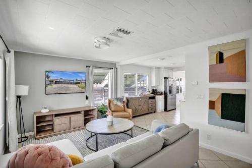 a living room with a couch and a table at Palm Wave Says - 5 Star - Quiet Area - Stocked in West Palm Beach