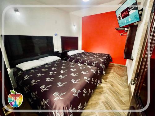 Voodi või voodid majutusasutuse HOTEL LA GRAN MANZANA toas