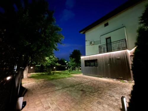 a house with a fence next to a brick driveway at Villa BB in Sarajevo