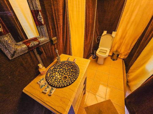 a bathroom with a sink and a toilet at Merzouga Tents © Official in Merzouga