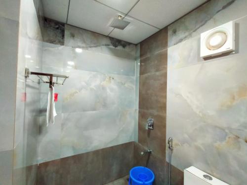 a bathroom with a shower and a toilet at West Coast Gokarna in Gokarna