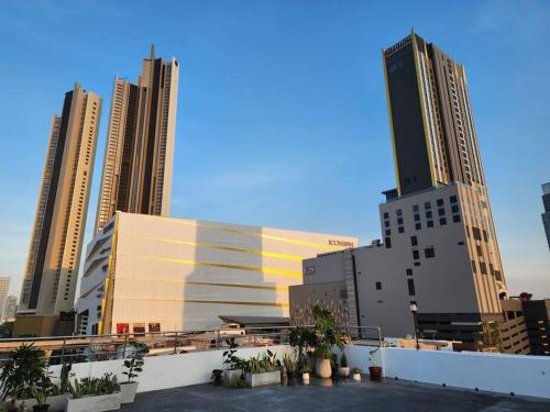 a group of tall buildings in a city at Rooftop Paradise & Koi Pond-6BR Hideaway@Icon Siam in Bangkok