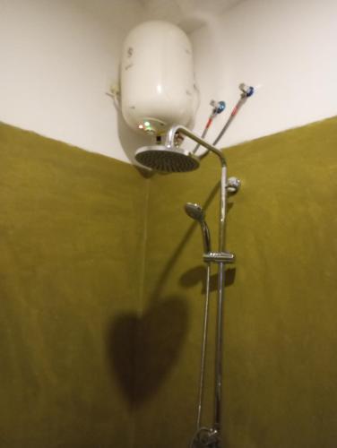 a bathroom with a shower with a light on the ceiling at Nade Villas Ahungalla in Ahungalla