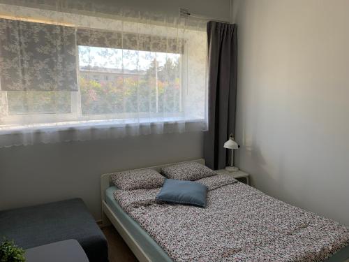 a bedroom with a bed with a pillow on it at Kihnu Sadama Öömaja in Lemsi