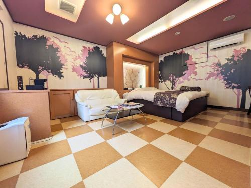 a bedroom with a bed and a checkerboard floor at SKY Bay-Terace Omura in Omura