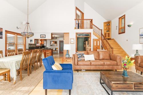 a living room with a couch and a table at Spacious Lakefront Retreat w/Stunning Views in Hinesburg