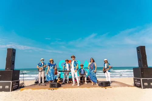 a group of people standing on the beach at Seaview Hotel - Arena Cam Ranh Resort in Cam Ranh