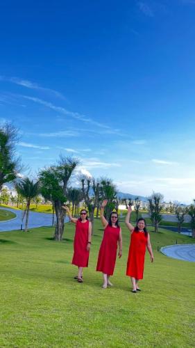 three women standing in a field with their hands in the air at Seaview Hotel - Arena Cam Ranh Resort in Cam Ranh