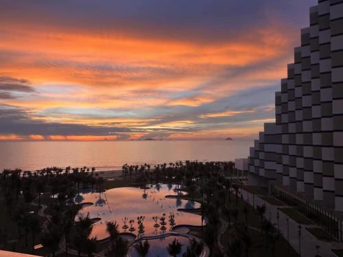 a sunset over the ocean and a resort at Seaview Hotel - Arena Cam Ranh Resort in Cam Ranh