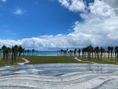 an empty amphitheater with palm trees and the ocean at Seaview Hotel - Arena Cam Ranh Resort in Cam Ranh