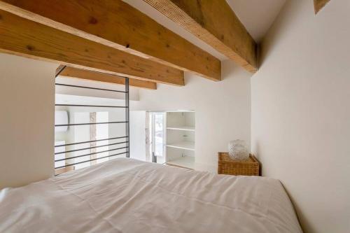 a white bedroom with a bed and a window at L'Onyx - Beau studio atypique coeur Presqu'île in Lyon