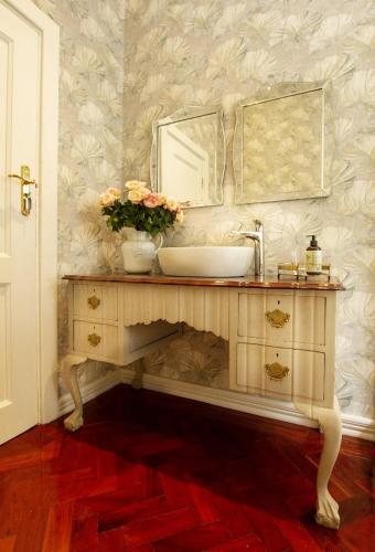 a bathroom with a sink and a mirror at The Great Gatsby Houghton in Johannesburg