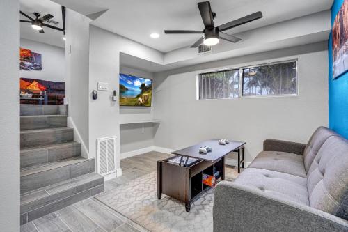 a living room with a couch and a table at Family Reunion, Remodeled, King Beds, X-box, Desks in Las Vegas