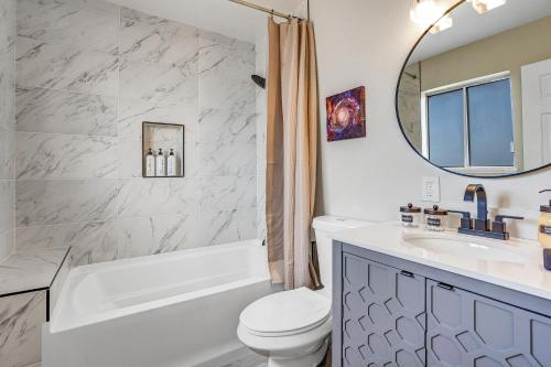 a bathroom with a tub and a toilet and a sink at Family Reunion, Remodeled, King Beds, X-box, Desks in Las Vegas