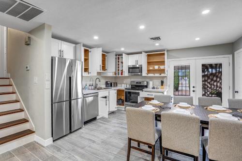 a kitchen and dining room with a table and a refrigerator at Family Reunion, Remodeled, King Beds, X-box, Desks in Las Vegas