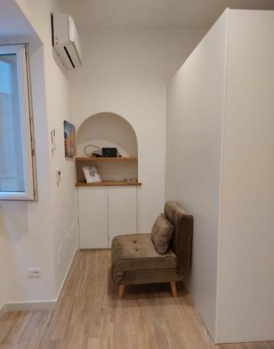 a living room with a chair and a window at Piccolo Borgo in Ischia