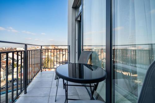 a balcony with a table and a view of a city at Modern Apollus Avenue - By OpenHouse apartments in Timişoara