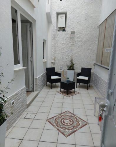 un patio con sillas y una mesa en un edificio en Piccolo Borgo, en Isquia