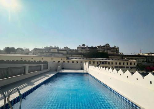 a swimming pool on the roof of a building at Manuscript - Jhilwara Haveli in Udaipur