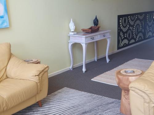 a living room with a couch and a table at Casablanca Penthouse Loft - Landmark 518 in Nelson Bay