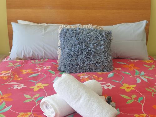 a bed with a stuffed animal and two rolls of toilet paper at Casablanca Penthouse Loft - Landmark 518 in Nelson Bay