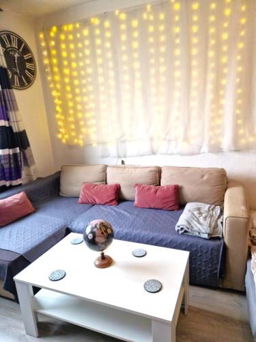 a living room with a couch and a table at Cozy trendy spacious room in green area 12 min. near to the center Alexanderplatz in Berlin