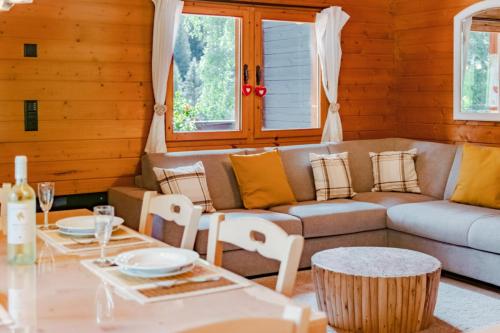 a living room with a couch and a table at Chalet Soleada - Happy Rentals 